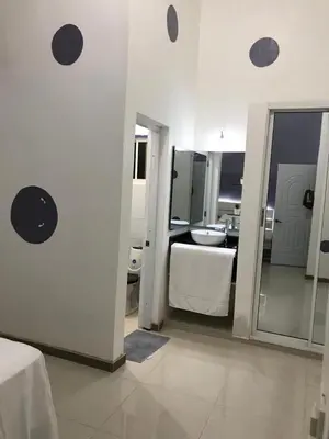a white bathroom with a sink and a mirror at Beautiful Villa in Boca Chica in Boca Chica
