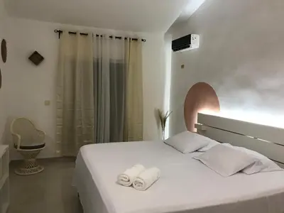 a bedroom with a white bed with towels on it at Beautiful Villa in Boca Chica in Boca Chica