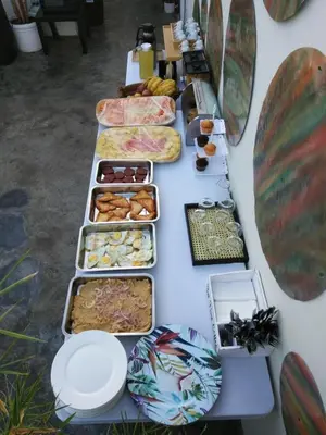 a long table with several trays of food on it at Studio 27 in Santo Domingo