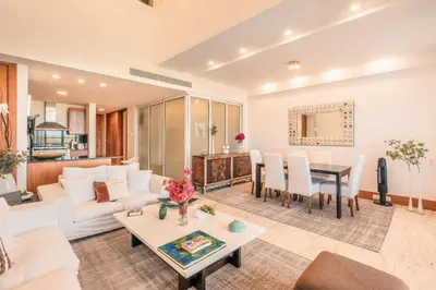 a living room with a white couch and a table at Golf View Apt at Casa De Campo in El Infiernito