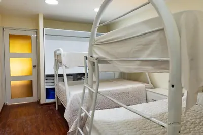 a bunk bed room with two bunk beds in it at Villas Club Ámbar in Cacique
