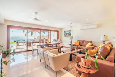 a living room with a couch and a table at 3BR Beachfront townhouse at Puerto Bahia in Santa Bárbara de Samaná