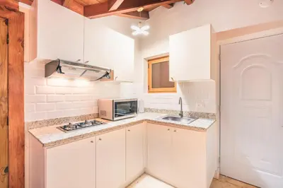 a white kitchen with a sink and a microwave at 3BR Beachfront townhouse at Puerto Bahia in Santa Bárbara de Samaná