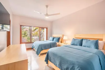 a bedroom with two beds and a window at 3BR Beachfront townhouse at Puerto Bahia in Santa Bárbara de Samaná