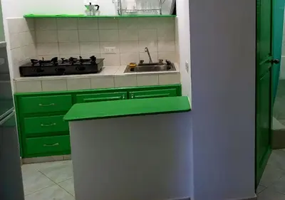 a kitchen with green cabinets and a sink at Residence Nord Est in Las Terrenas