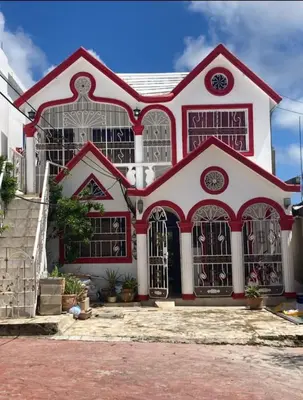 a red and white house with a lot of windows at Samana house in Santa Bárbara de Samaná