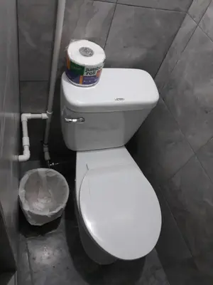 a toilet with a container on top of it in a bathroom at Casa De Matias in Las Terrenas
