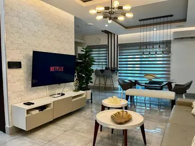 a living room with a tv on a wall at SOHA SUITES II in Santiago de los Caballeros