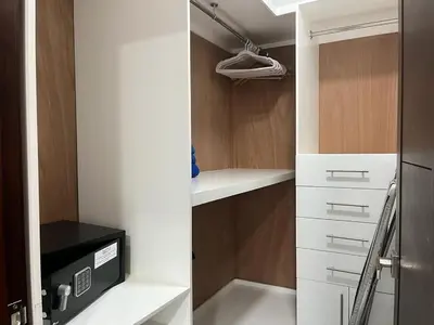 a kitchen with white cabinets and a refrigerator at SOHA SUITES II in Santiago de los Caballeros