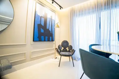 a living room with a table and a chair at SOHA PANORAMA in Santiago de los Caballeros