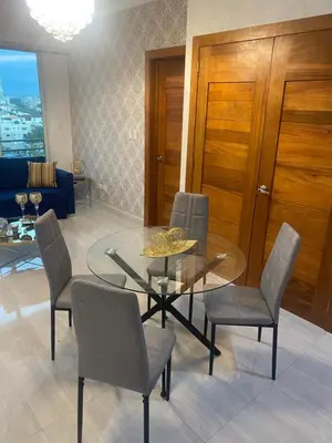 a dining room with a glass table and chairs at Torre Harriannet XIII in Santo Domingo