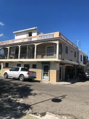 a white car parked in front of a building at Apartamentos Kika in San Felipe de Puerto Plata