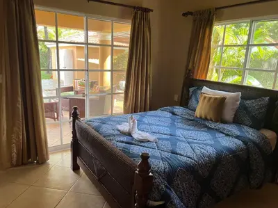 a bedroom with a bed and a large window at Charming 3 bedroom villa 66 with private pool in Sosúa