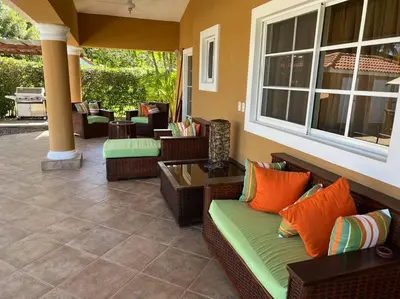 a porch with wicker chairs and a patio at Charming 3 bedroom villa 66 with private pool in Sosúa