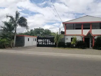a sign on the side of a street next to a building at Piscalonga Hotel Restaurant Cozy Family Operated in San Lorenzo de Guayubín