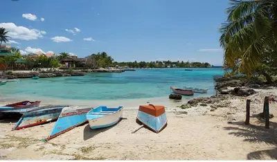 a group of boats sitting on a beach at Gaviota Paradise in La Romana
