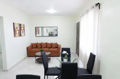 a living room with a couch and a glass table at Gaviota Paradise in La Romana