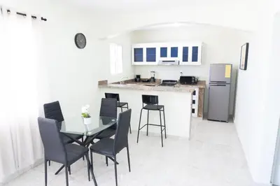 a kitchen and dining room with a table and chairs at Gaviota Paradise in La Romana