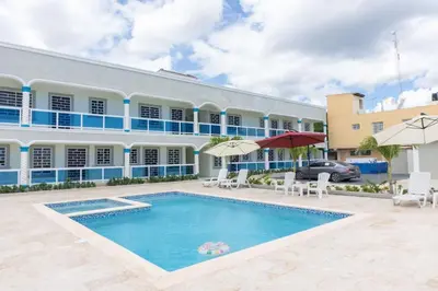 a hotel with a swimming pool in front of a building at Gaviota Paradise in La Romana