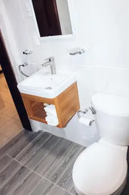 a bathroom with a white toilet and a sink at Acogedor estudio 7 en la Zona Colonial in Santo Domingo