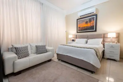 a bedroom with a bed and a couch in it at Acogedor estudio 7 en la Zona Colonial in Santo Domingo
