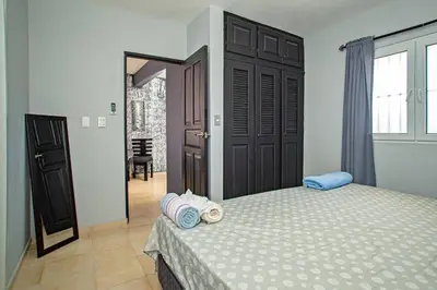 a bedroom with a bed with two pillows on it at One Bedroom Apartment in Sosua , Great for Remote Workers Fast Wifi in Sosúa