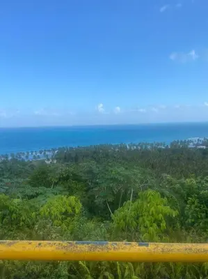 a yellow rail with the ocean in the background at One Bedroom Apartment in Sosua , Great for Remote Workers Fast Wifi in Sosúa