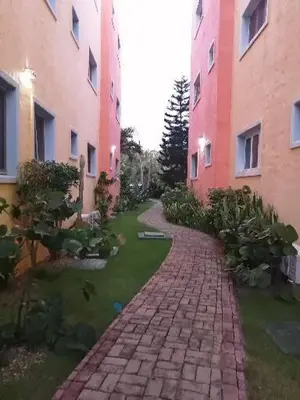a brick walkway between two buildings in a yard at Hermoso apartamento de playa en perla marina Sosua - Cabarete in Sosúa