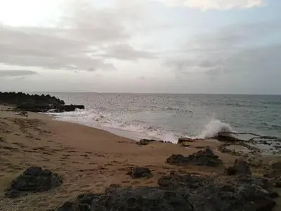a beach with waves crashing on the shore at Hermoso apartamento de playa en perla marina Sosua - Cabarete in Sosúa