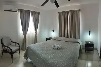 a bedroom with a bed and a chair and a window at Minerva in La Ureña