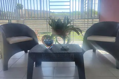 a table with a potted plant on it next to two chairs at Minerva in La Ureña