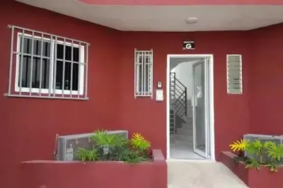 a red house with a door and plants in front at Minerva in La Ureña