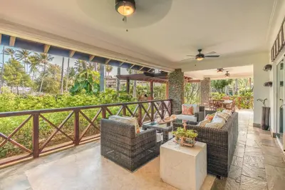 a living room with two couches on a balcony at Glamorous w Jacuzzi Balcones del Atlntico in Portillo