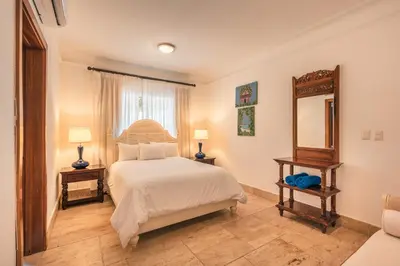 a bedroom with a large bed and a mirror at Glamorous w Jacuzzi Balcones del Atlntico in Portillo