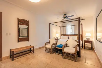 a bedroom with a bed and a chair and a mirror at Glamorous w Jacuzzi Balcones del Atlntico in Portillo