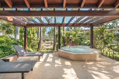 a hot tub on a patio with two chairs at Glamorous w Jacuzzi Balcones del Atlntico in Portillo