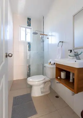 a bathroom with a toilet and a sink and a shower at EDMA APARTAHOTEL in Santa Bárbara de Samaná