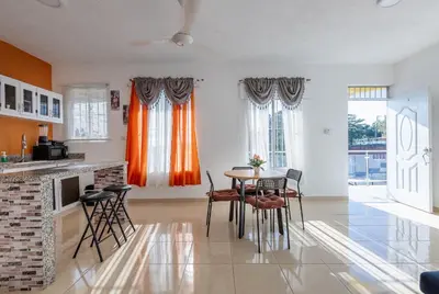a kitchen with a table and chairs in a room at EDMA APARTAHOTEL in Santa Bárbara de Samaná