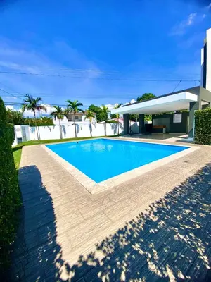 a swimming pool in front of a house at Acogedor apartment , seguridad las 24 horas , Cibao International Airport 8 minutos, Centro de Santiago 10 Minutos , Tamboril la capital mundial del cigarro 10 minutos in Licey al Medio