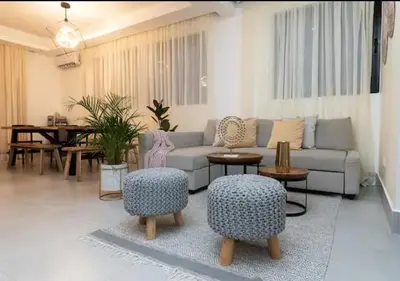 a living room with a couch and chairs and a table at Torre Rialto in Santiago de los Caballeros