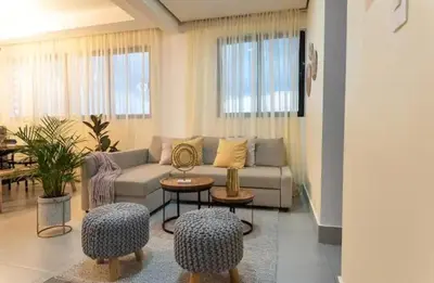 a living room with a couch and a table at Torre Rialto in Santiago de los Caballeros