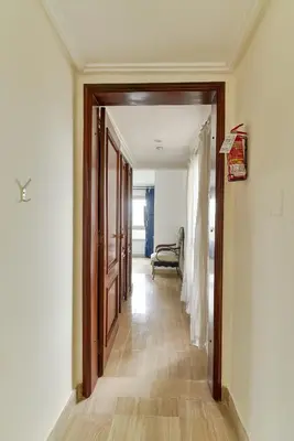 a hallway with a door and a chair in a room at Exquisite Oceanfront Suite in Santo Domingo