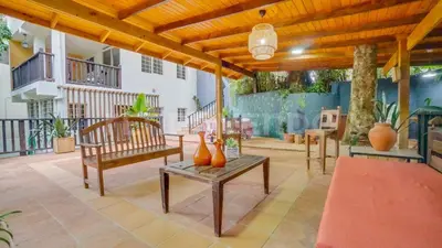 a patio with benches and vases on it at El Yaguacil villa in Jarabacoa