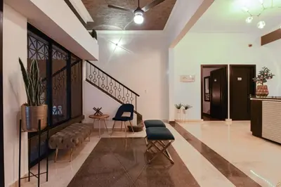 a lobby of a building with chairs and a staircase at PH 19 Guesthouse Hotel in Gazcue in Santo Domingo