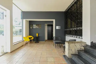a living room with chairs and a table at PH 19 Guesthouse Hotel in Gazcue in Santo Domingo
