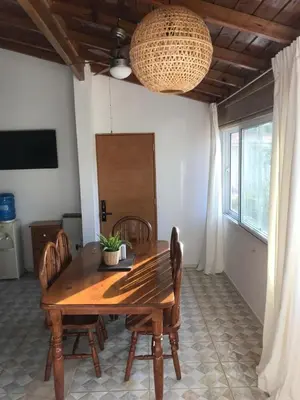 a dining room with a wooden table and chairs at La Cortesana Cozy Apt Steps to the Beach in Las Terrenas