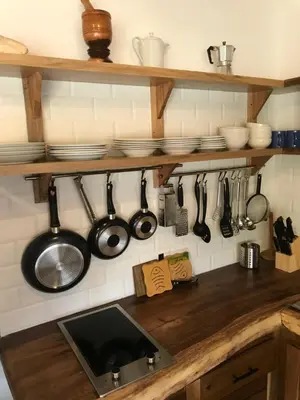 a kitchen counter with pots and pans and utensils at La Cortesana Cozy Apt Steps to the Beach in Las Terrenas