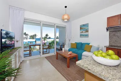 a living room with a couch and a table at Amazing ocean view apartment with grand pool in Cabarete