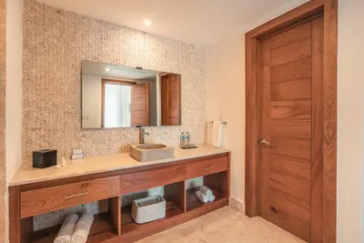a bathroom with a sink and a mirror at Go away to this charming apt at Sublime w private jacuzzi included in Las Terrenas