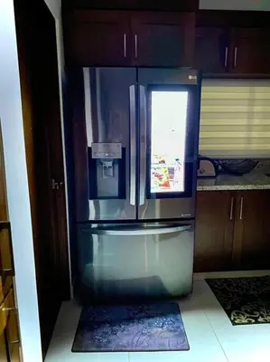 a refrigerator with a window in a kitchen at Spectacular PentHouse with private jacuzzi terrace in Santiago de los Caballeros